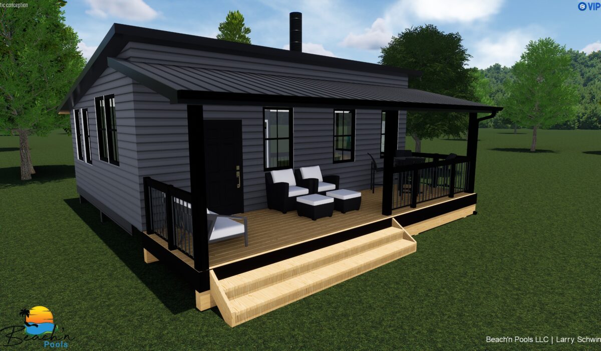 Small modern gray house with black trim and a covered wooden porch, outdoor seating in a grassy yard with trees nearby.