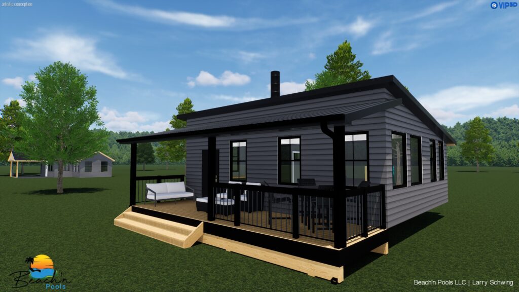 Modern gray house with black trim and large windows on a wooden deck, surrounded by green lawn and trees under a blue sky.